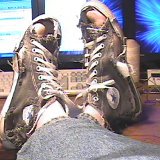Trashed High Top Chucks  Lounging in a pair of well worn and threadbare black high tops.