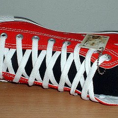 Red/Black 2-Tone High Top Chucks  Left red and black 2-tone high top, new with tag, sideways top view.
