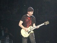 U2  The Edge in concert wearing black high top chucks.