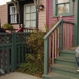 About a Boy  Marcus seated on a doorstep wearing black high top chucks.