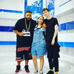 Alessia Cara  Alessia Cara poses with DJ Khaled and Troye Sivan while wearing black low cut chucks.