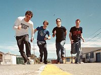 Allister  Tim, Scott, Kyle, and Mike run together on a street.