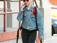 Amanda Seyfried  Amanda's grey chucks are a favorite of hers for walking the streets of New York City.  (Photo by Ignat/Bauer) : denim jacket, sunglasses, black, tights, Converse, sneakers, earbuds, 150415B6