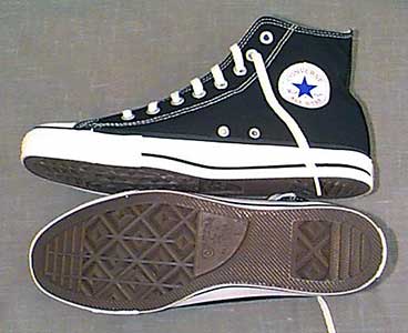 Inside patch and sole views of black high top Chuck Taylor sneakers