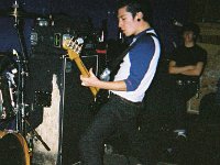 Atreyu  Bass player Marc McKnight performing in blue low cut chucks.