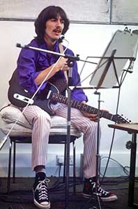 George Harrison wearing black high top chucks