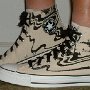 Black Sabbath High Top Chucks  Wearing tan and black print  Black Sabbath high tops with black retro shoelaces, left side view 1.