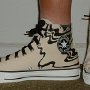 Black Sabbath High Top Chucks  Wearing tan and black print  Black Sabbath high tops with black retro shoelaces, left side view 2.