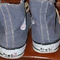 Brad Deniston Collection of Chucks  Rear view of distressed blue denim high tops with hemp shoelaces.