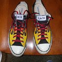 Brad Deniston Collection of Chucks  Top view of black flames low cut chucks with black and red reversible shoelaces.