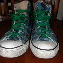 Brad Deniston Collection of Chucks  Front view of blue camouflage high tops with green shoelaces.