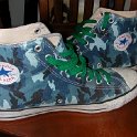 Brad Deniston Collection of Chucks  Inside patch views of blue camouflage high tops with green shoelaces.