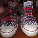 Brad Deniston Collection of Chucks  Front view of black and white checkered low cut chucks with red and black reversible laces.