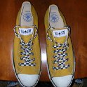 Brad Deniston Collection of Chucks  Top view of gold low cut chucks with black and white checkered laces.