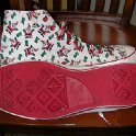 Brad Deniston Collection of Chucks  Outside and sole views of Santa print high top chucks.