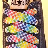 Rainbow Checkered Print Shoelaces On Chucks  Rainbow checkered print shoelace on a navy blue low top chuck.