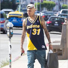 Chris Brown  Chris Brown in optical white chucks while wearing a Reggie Miller throwback jersey. : paparazzi