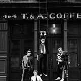 Something Corporate  Band members posed in front of a coffee shop.