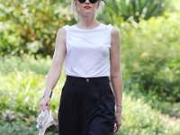Gwen Stefani  Outdoors shot in a white blouse, black pedal pushers, and black low top chucks.