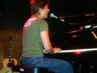 Hanson  Isaac performing on a grand piano.