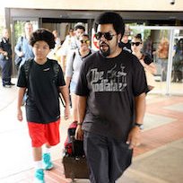 Ice Cube  Ice Cube wearing black chucks while walking with his son.