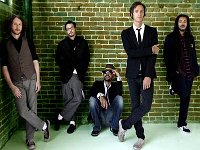 Incubus  Posed shot of the band with Brandon in black low cut chucks and Mike in white low cut chucks.