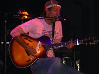 Jason Mraz  Performing in well worn white high tops.