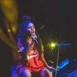 Jessie Reyez  Jessie Reyez performing in red high top chucks.