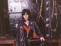 Joan Jett  Joan Jett wearing black high tops backstage.