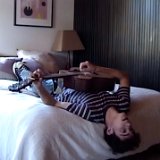 Joshua Bassett  Joshua lying on his bed playing the guitar.