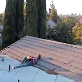 Joshua Bassett  Joshua lying on a roof playing and singing, shot 1.