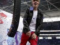 Justin Bieber  Justin Bieber on stage wearing black high top chucks.