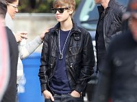 Justin Bieber  Justin Bieber wearing black high top chucks.