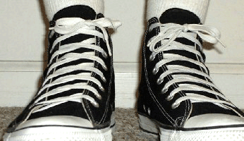 Classic lacing on a Converse All Star Chuck Taylor black high top.