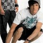 People Wearing Low Top Chucks  Older teen on skateboard wearing black low top chucks.