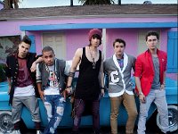 Midnight Red  The band posed in front of a classic car.