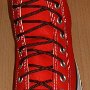 Narrow Round Shoelaces  Red high top with narrow brown laces.