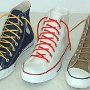 Narrow Round Shoelaces  Navy blue high top with narrow yellow shoelaces, optical white high top with narrow red shoelaces, and taupe high top with tan shoelaces.