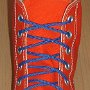 Narrow Round Shoelaces  Orange high top with narrow royal blue laces.