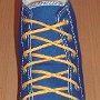 Narrow Round Shoelaces  Royal blue high top with narrow yellow laces.