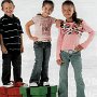 Chucks Worn By Prre-Teen Boys and Girls in Ads  Young boy wearing black chucks with young girls wearing optical white and pink chucks.