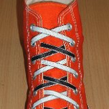 Reversible Shoelaces On Chucks  Orange high top with black and white reversable laces.