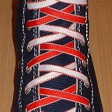 Reversible Shoelaces On Chucks  Navy blue high top with red and white reversable laces.