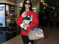 Rihanna  Rihanna walking through a mall wearing black high top chucks.
