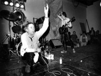 The Sex Pistols  December, 1976 performance. Guitarist Steve Jones is wearing chucks. : England, black, &, white, format, landscape, male, equipment, audio, equipment, musical, instrument, microphone, light, Music, Personality, British, English, Eu, 76, 6539, FR, 9A, ES, P/THE, SEX, PISTOLS