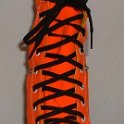 Skate Shoelaces on Knee High Chucks  Black 96 inch shoelaces on a left orange knee high.