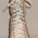 Skate Shoelaces on Knee High Chucks  White 96 inch shoelaces on a left parchment knee high.