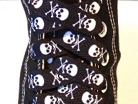 Skull Print Shoelaces On Chucks  Black and white skull print shoelace on a black high top.
