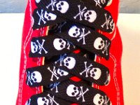 Skull Print Shoelaces On Chucks  Black and white skull print shoelace on a red high top.