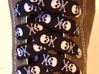 Skull Print Shoelaces On Chucks  Black and white skull print shoelace on a grey high top.